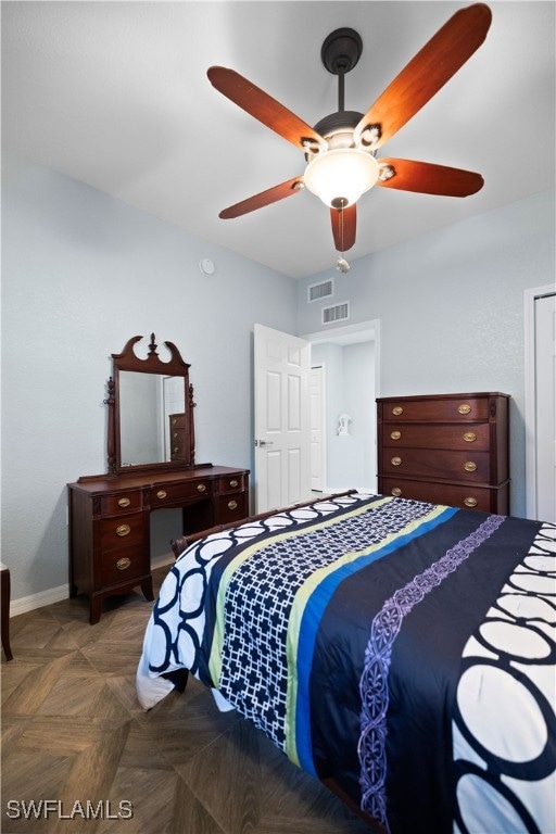 bedroom featuring ceiling fan and dark parquet flooring