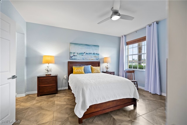 bedroom with ceiling fan and light parquet flooring