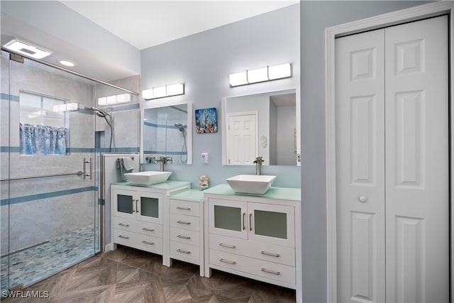 bathroom with vanity, an enclosed shower, and parquet flooring