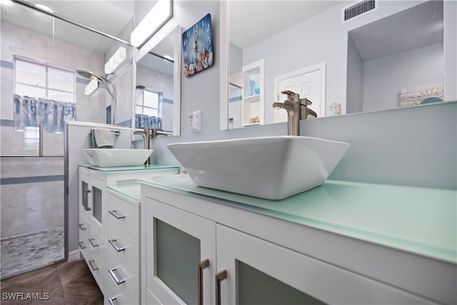 bathroom featuring vanity, a healthy amount of sunlight, and parquet floors