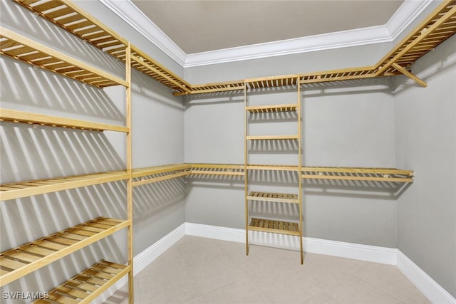 walk in closet with tile patterned floors