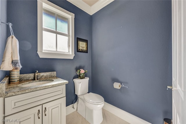 bathroom with vanity, toilet, baseboards, and tile patterned flooring