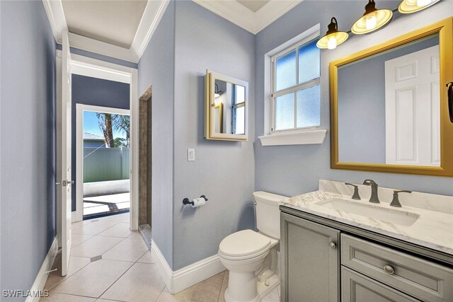 bathroom featuring vanity, baseboards, ornamental molding, tile patterned flooring, and toilet