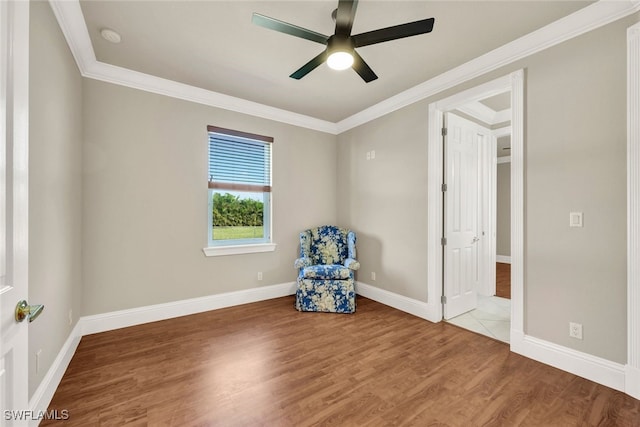 unfurnished room featuring hardwood / wood-style flooring, ceiling fan, and crown molding