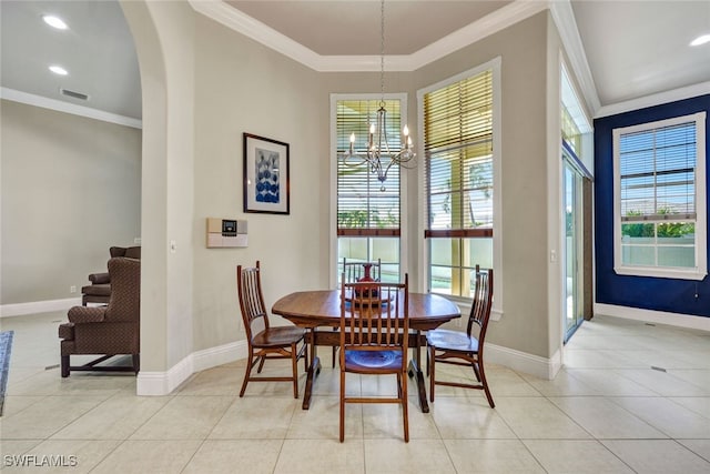 dining space featuring light tile patterned floors, plenty of natural light, baseboards, and ornamental molding