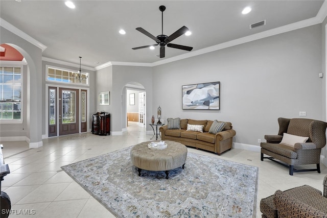 living room with crown molding, light tile patterned floors, and ceiling fan with notable chandelier