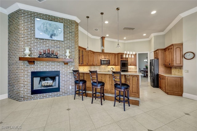 kitchen featuring stainless steel appliances, kitchen peninsula, a kitchen bar, light tile patterned floors, and ornamental molding