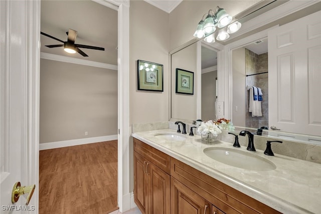 bathroom featuring hardwood / wood-style flooring, ceiling fan, and ornamental molding