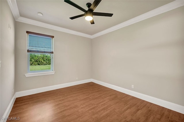 spare room with ornamental molding, ceiling fan, baseboards, and wood finished floors