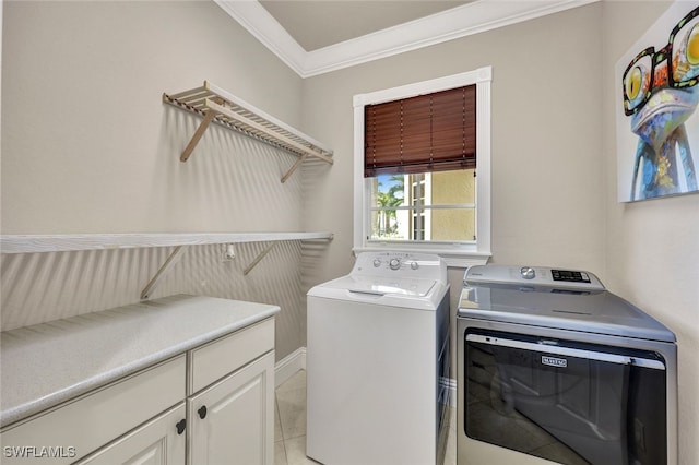 washroom featuring washer and dryer, light tile patterned floors, ornamental molding, and cabinets