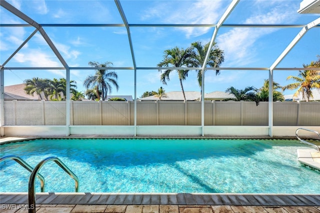 view of pool with glass enclosure