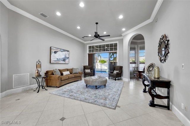 living room with ceiling fan, light tile patterned floors, and crown molding