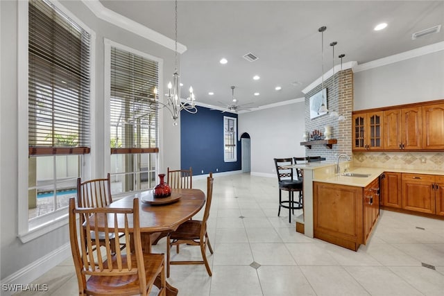 dining space featuring light tile patterned floors, ceiling fan with notable chandelier, ornamental molding, and sink