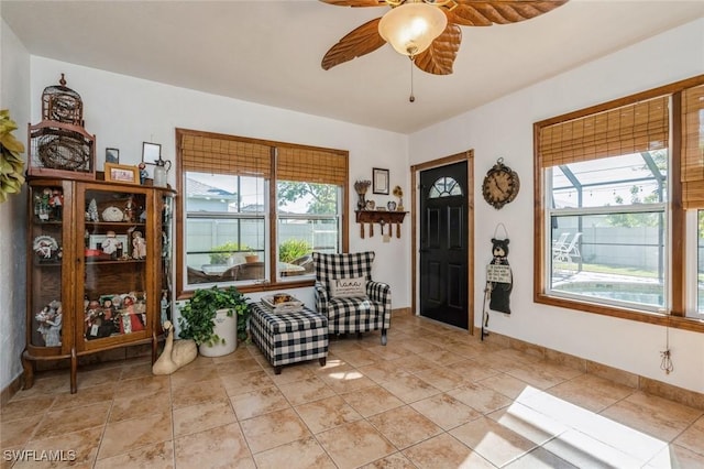 living area with ceiling fan