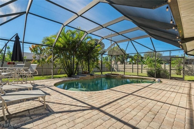 view of swimming pool with a lanai, a hot tub, and a patio