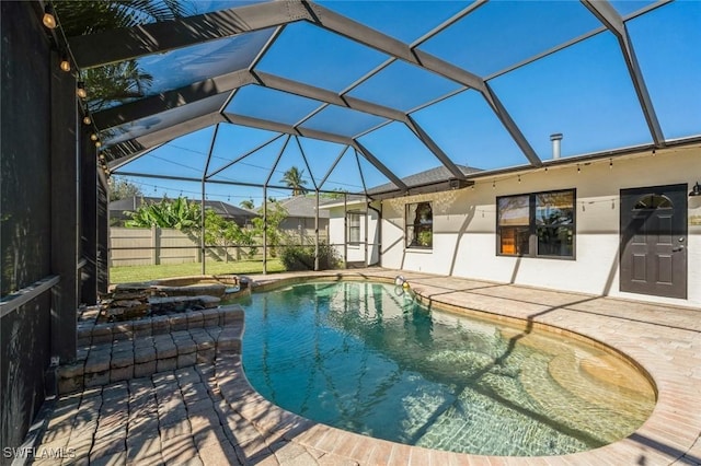 view of swimming pool featuring a lanai and a patio area