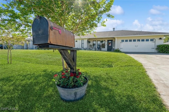 view of front of property featuring a garage and a front yard