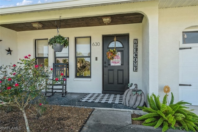 doorway to property with a porch