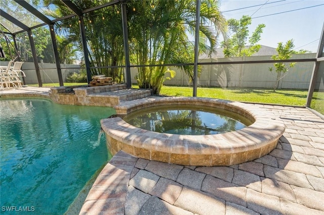 view of swimming pool with an in ground hot tub, a lanai, and a patio