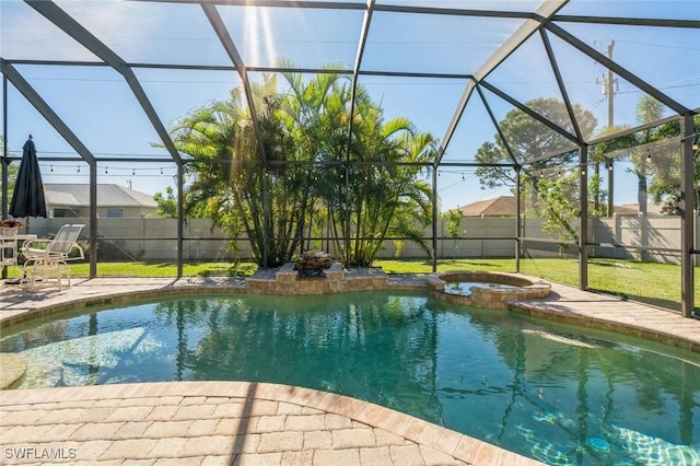 view of swimming pool with an in ground hot tub, a lanai, and a patio area