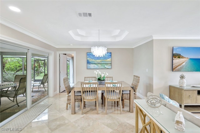 dining room featuring ornamental molding and a notable chandelier