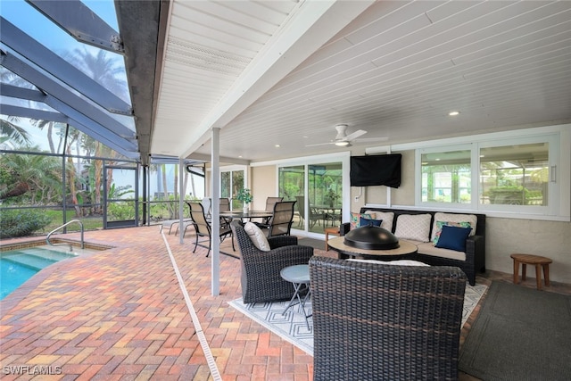 sunroom featuring ceiling fan, a swimming pool, beamed ceiling, and a healthy amount of sunlight