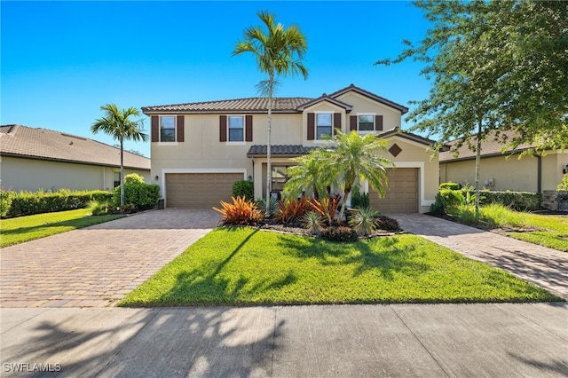 view of front facade featuring a front yard and a garage