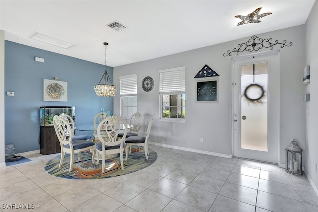 dining room with an inviting chandelier and light tile patterned flooring