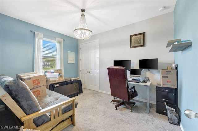 office area featuring a notable chandelier and light colored carpet