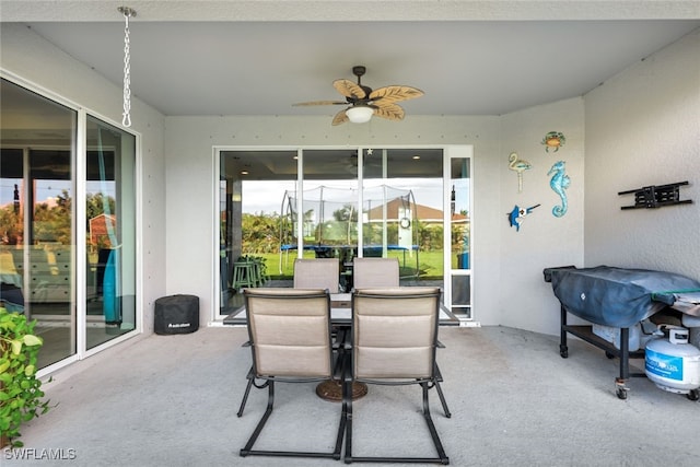 sunroom / solarium featuring ceiling fan