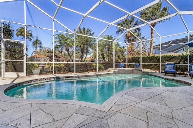 view of swimming pool featuring glass enclosure and a patio