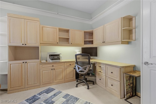 office space featuring built in desk, light colored carpet, and crown molding