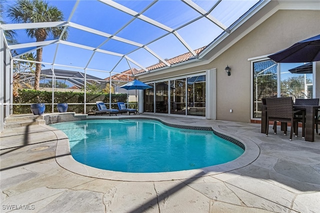 view of pool featuring a patio and glass enclosure