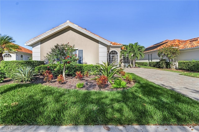 mediterranean / spanish-style house with a front lawn