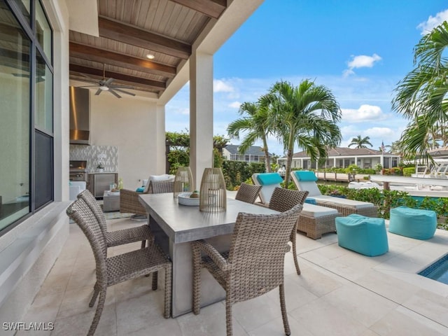 view of patio / terrace with ceiling fan, grilling area, and an outdoor kitchen