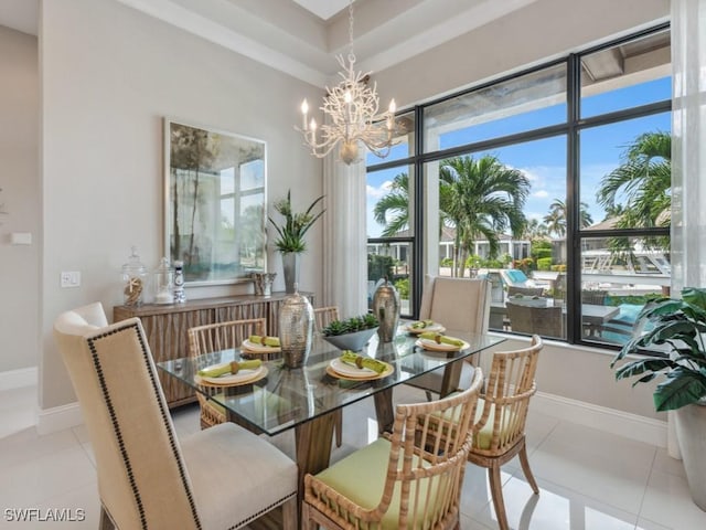 tiled dining room featuring an inviting chandelier