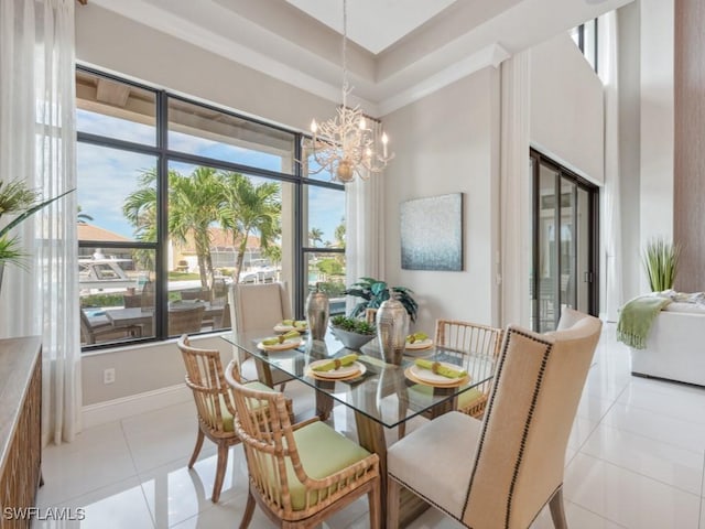 tiled dining space with a high ceiling and a notable chandelier