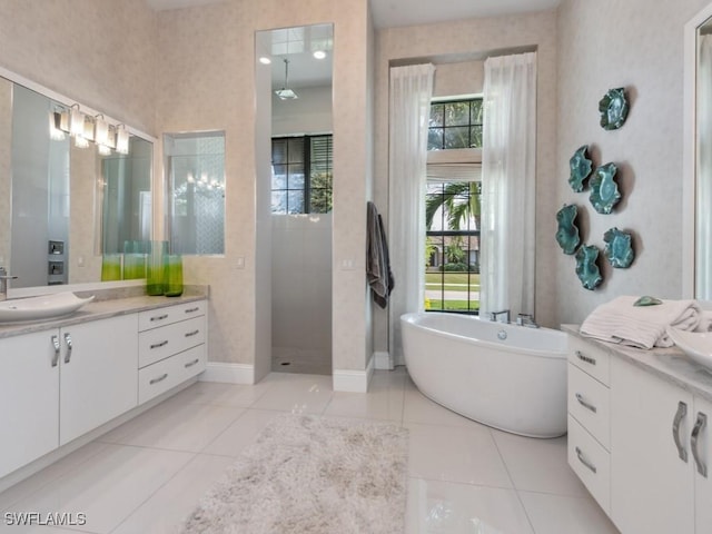 bathroom with tile patterned floors, vanity, and independent shower and bath