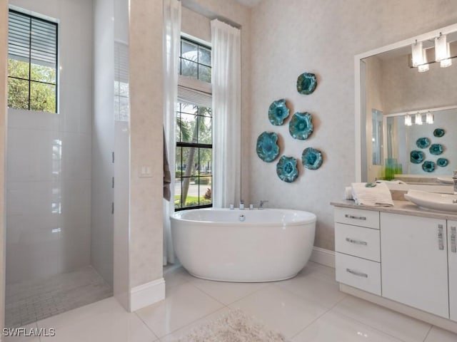 bathroom featuring tile patterned flooring, vanity, and shower with separate bathtub