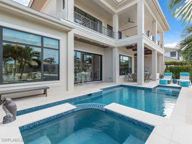 view of pool with ceiling fan, an in ground hot tub, and a patio