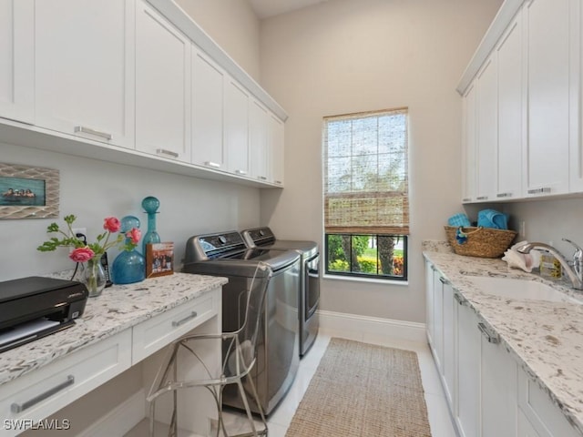 washroom featuring cabinets, independent washer and dryer, light tile patterned floors, and sink