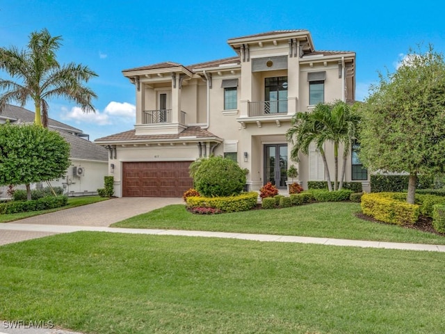 view of front of property with a garage, a balcony, and a front yard