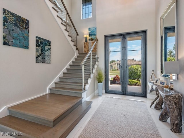 tiled foyer featuring a high ceiling