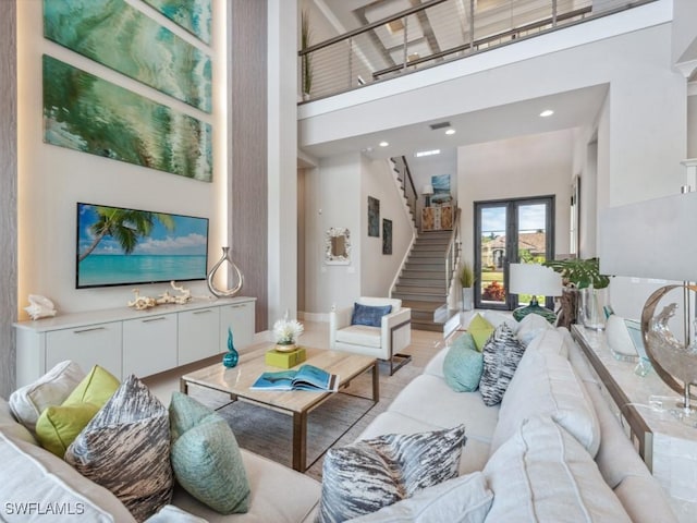 living room with a towering ceiling and french doors