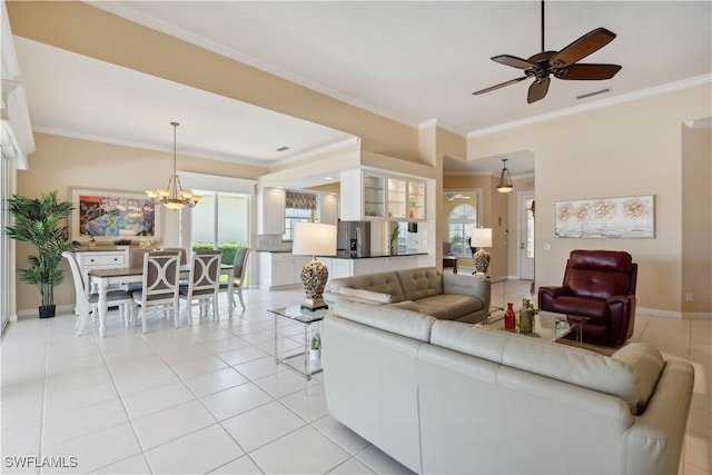 tiled living room with crown molding and ceiling fan with notable chandelier