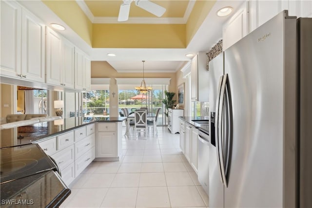 kitchen with white cabinetry, hanging light fixtures, ornamental molding, and stainless steel appliances