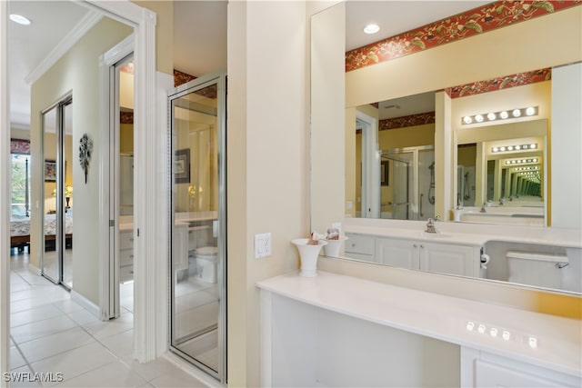 bathroom with tile patterned floors, vanity, and a shower with shower door