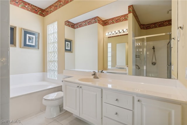 full bathroom featuring tile patterned flooring, vanity, shower with separate bathtub, and toilet