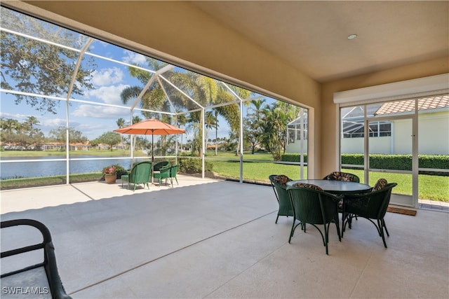 view of patio featuring a lanai and a water view