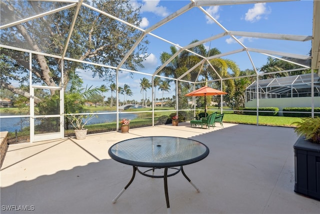 view of patio / terrace with a water view and glass enclosure